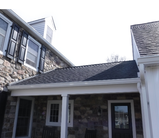 Kickout flashing installed along a roof of a stone home