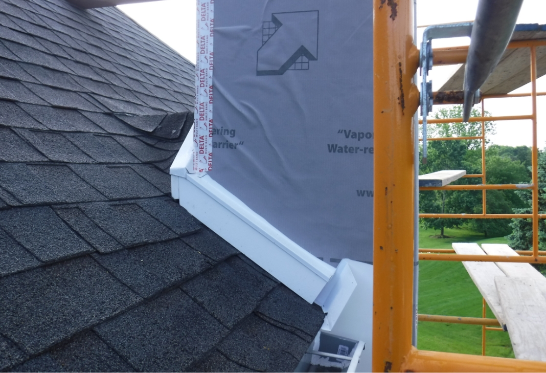 Close-up of kickout flashing being installed on a roof
